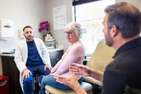 Patient discussing health concerns with a doctor, illustrating the gap between medical opinions and Social Security decisions.